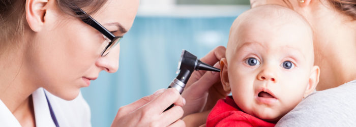 Pediatrician using otoscope